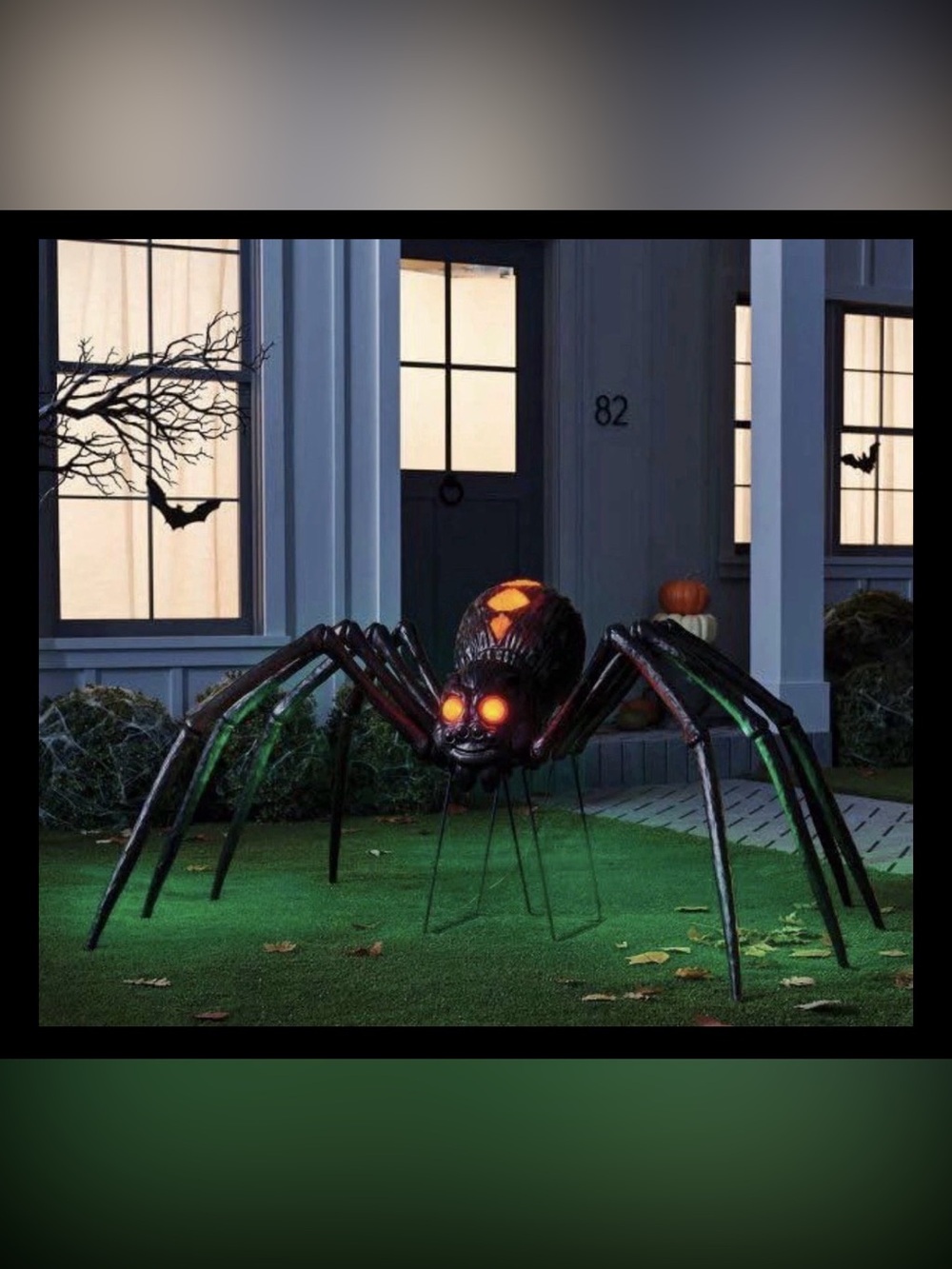 Giant Black Halloween Spider Sculpture with Glowing Orange Eyes